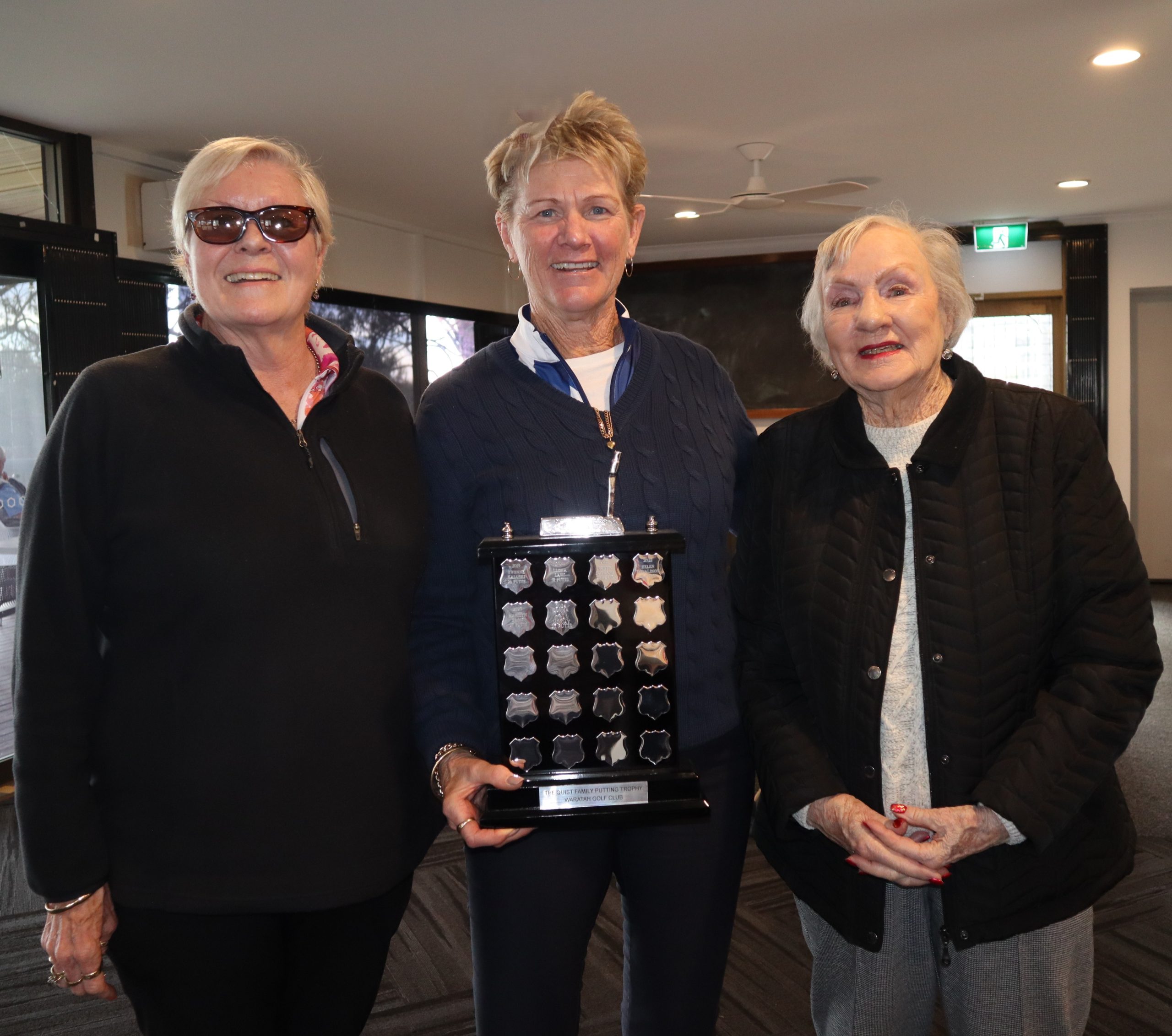Quist Family Putting Trophy Winner - Renay Robertson being presented by Jenny and Corinne Quist
